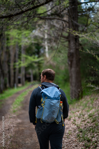 male hiker photographer hiking in the woods of Traful lake in Patagonia mountains in Argentina