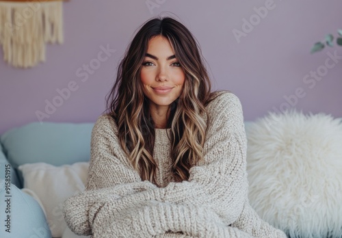 beautiful woman in her thirties wearing an oversized sweater sitting on the couch