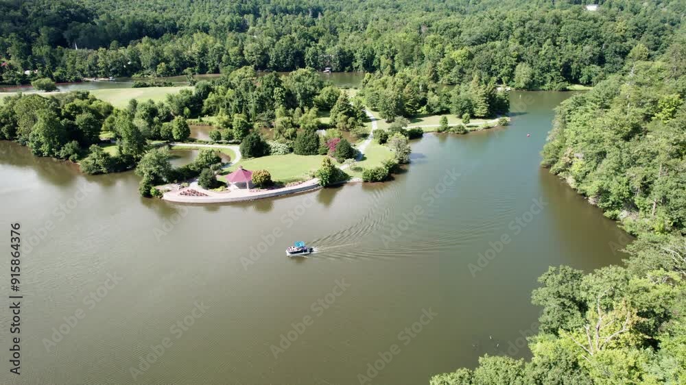 Pontoon boat motors past gazebo on Lake Lure in North Carolina Pontoon boat motors past gazebo on Lake Lure in North Carolina