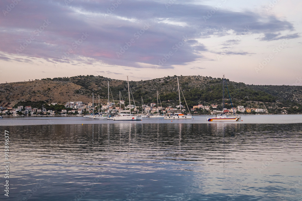 Sailing boats anchored in bay of the town of Rogoznica, during summer sunset Sailing boats anchored in bay of the town of Rogoznica, during summer sunset