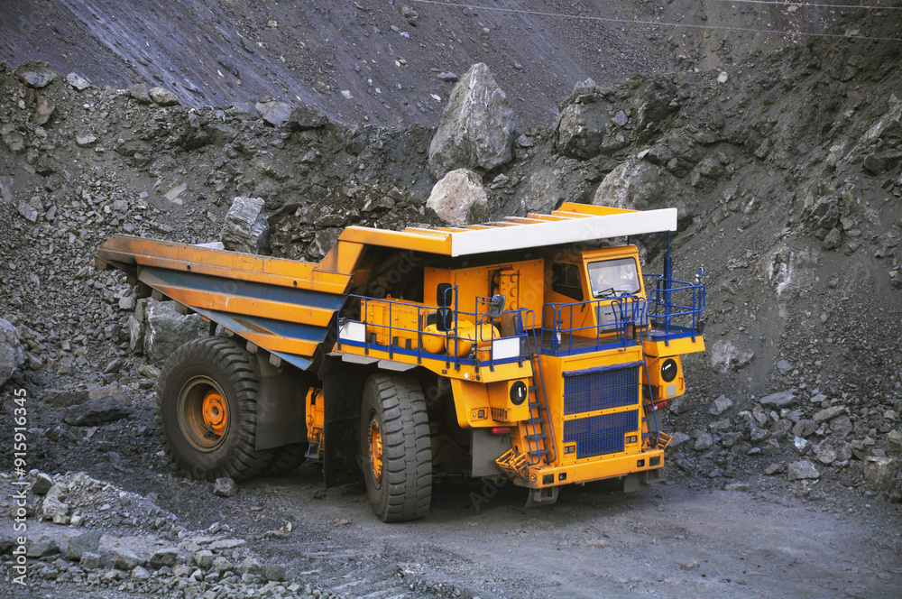 A large mining dump truck transports ore in a quarry A large mining dump truck transports ore in a quarry
