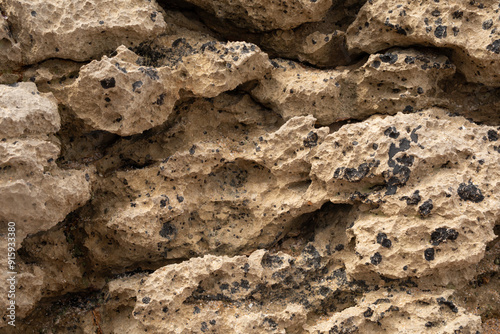 Rough textured rock face wi...