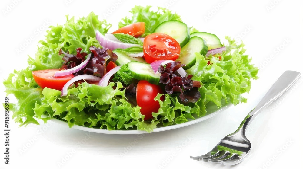 A colorful salad made with fresh lettuce, tomatoes, cucumbers, and onions on a white plate A colorful salad made with fresh lettuce, tomatoes, cucumbers, and onions on a white plate