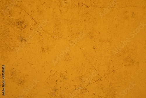 A close up of a weathered yellow wall photo