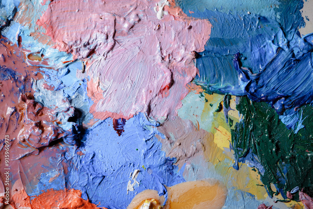 Fototapeta premium Colorful abstract texture. Smears of oil paint and a palette knife on an art palette. The concept of the modern school of art. Fragment of creative work. Colors of the year 2024