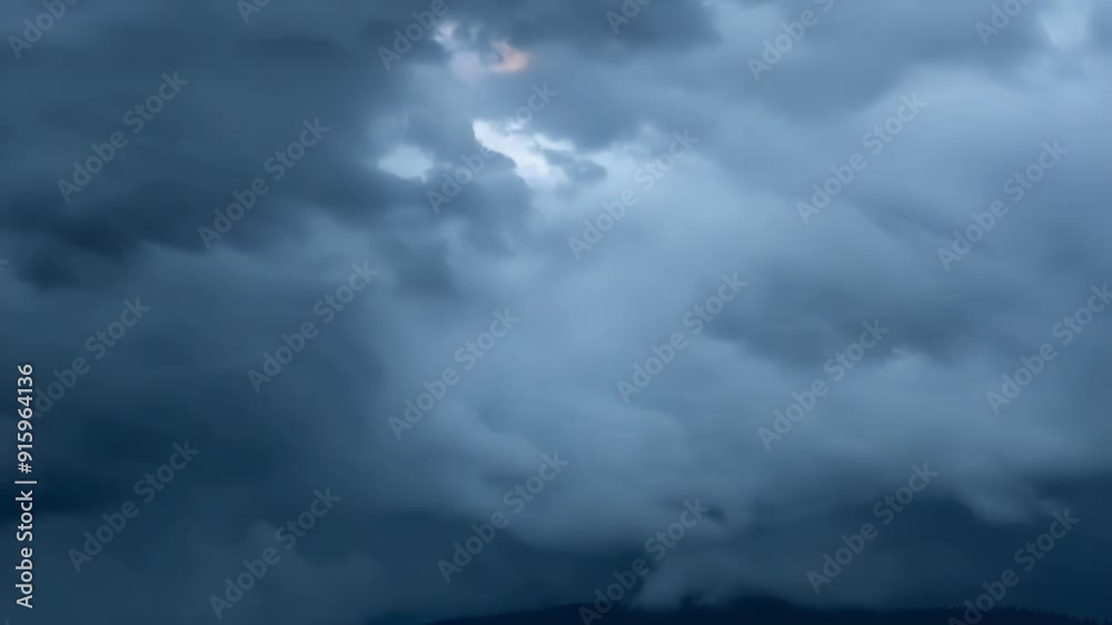 A closeup shot of dark grey storm clouds rolling and cascading over one another. A closeup shot of dark grey storm clouds rolling and cascading over one another.