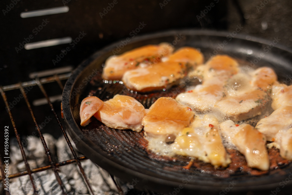 Chicken sizzling on the grill ready for a delicious meal Chicken sizzling on the grill ready for a delicious meal