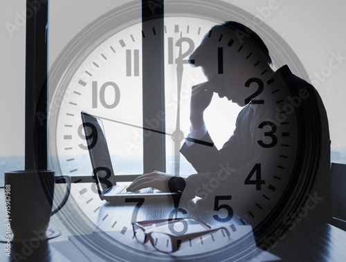 Stressed exhausted business man working overtime in office photo