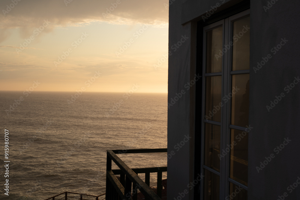 A window with a view of the ocean at sunset The perfect escape