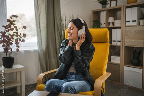 Adult woman with headphones listen to music on mobile phone