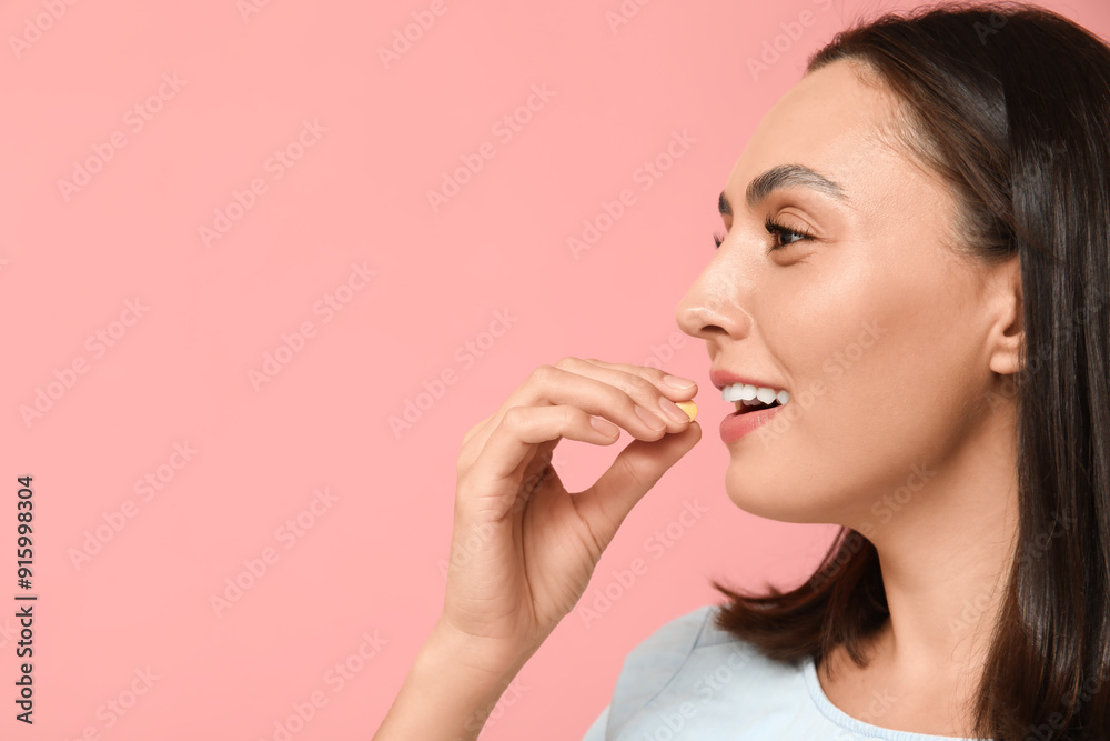 Pretty young woman taking pill on pink background, closeup Pretty young woman taking pill on pink background, closeup
