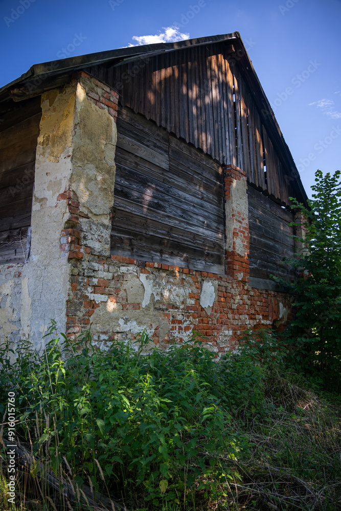 The side of a crumbling brick building. The side of a crumbling brick building.