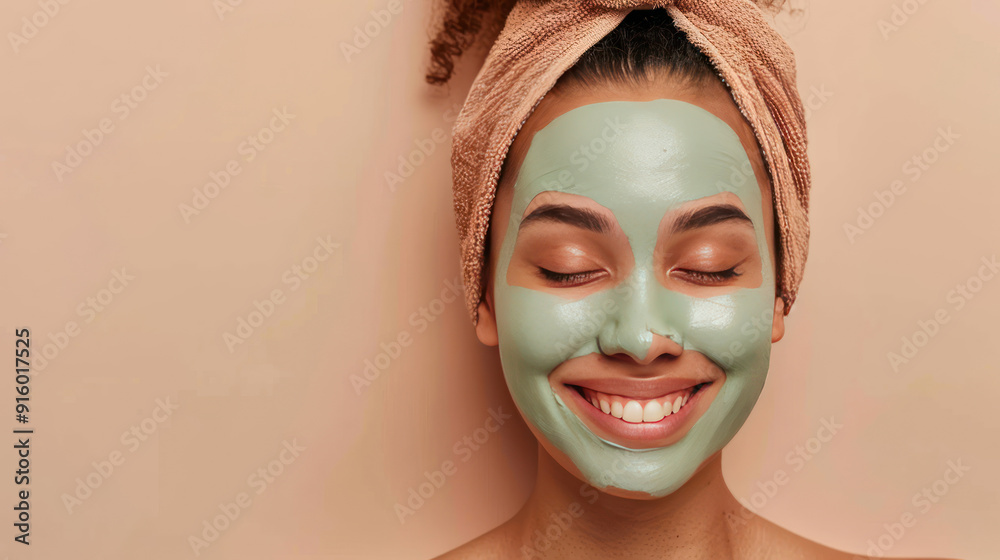 Satisfied young woman applying a clay face mask, achieving smooth and fresh skin, on a beige background Satisfied young woman applying a clay face mask, achieving smooth and fresh skin, on a beige background