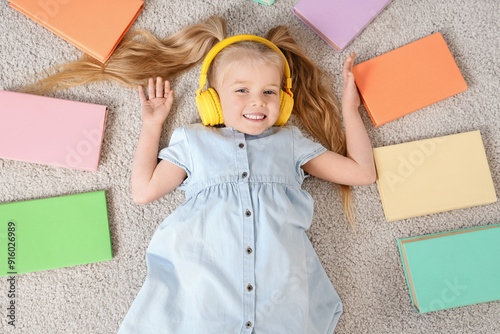 Cute little girl in headpho...