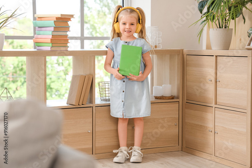 Cute little girl in headpho...