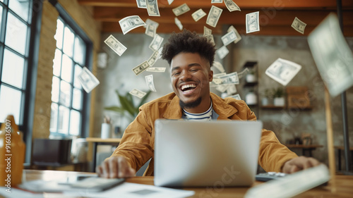 Internet Wealth: Man Using Laptop with Scattered Money Falling Around
