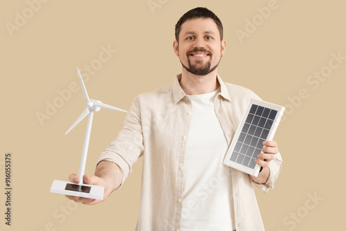 Young man with wind turbine...