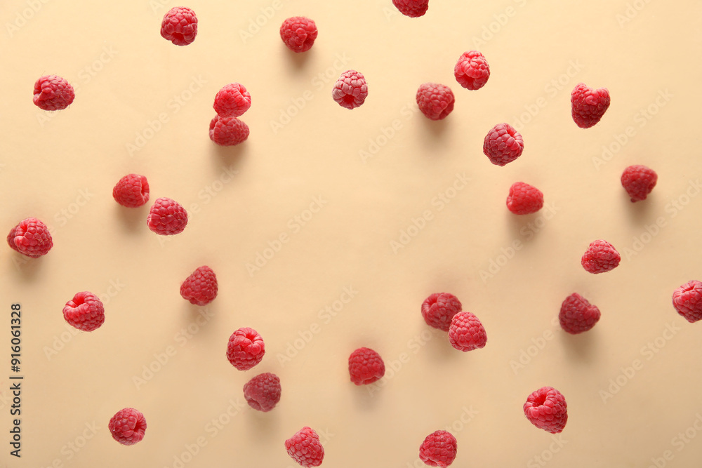 Frame made of raspberries flying on beige background, closeup Frame made of raspberries flying on beige background, closeup