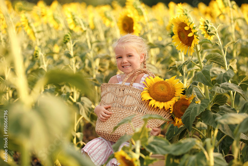 Cute little girl holding ba...