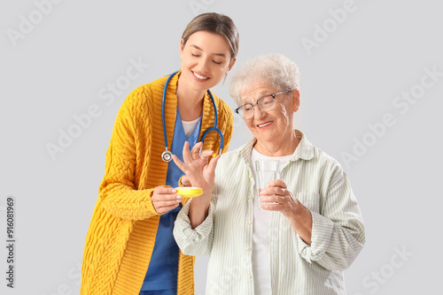 Senior woman taking pill fr...