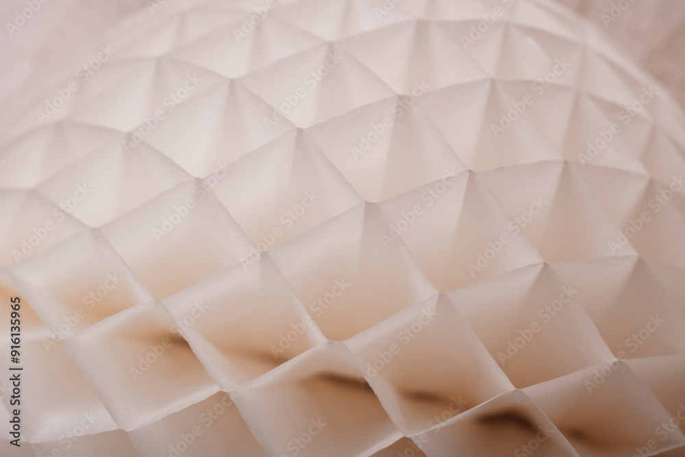 Fototapeta premium A detailed close-up of a white paper honeycomb decoration