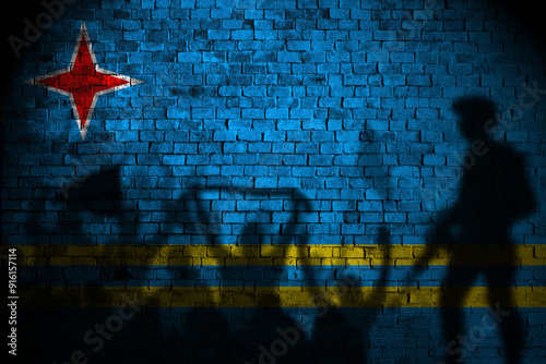 aruba flag painting on brick wall and Protesters shadow photo