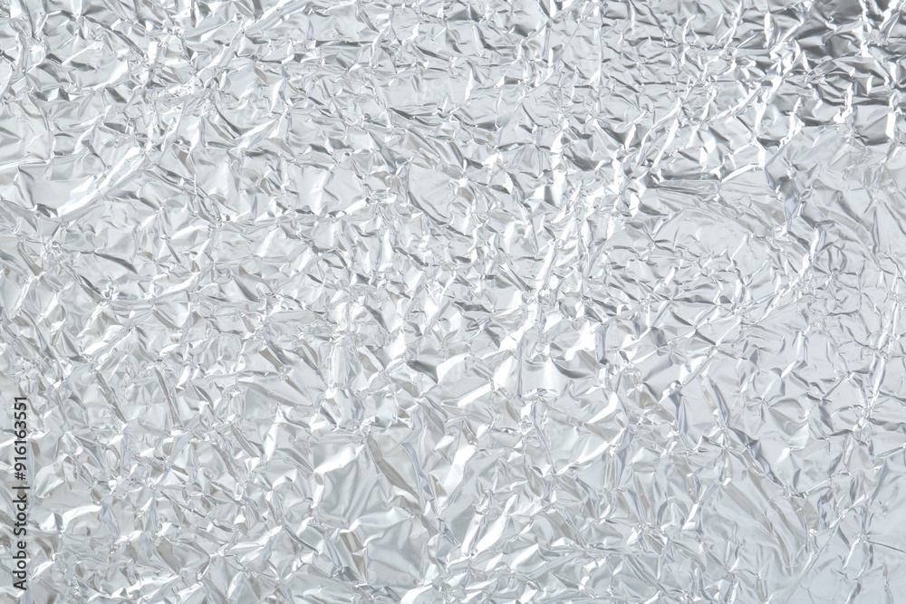 Shiny silver tinfoil surface as background, top view Shiny silver tinfoil surface as background, top view