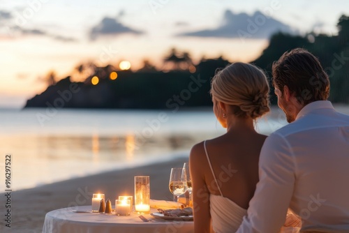 Romance by the Sea: Elegant Couple Enjoying Candlelit Dinner on Private Beach photo