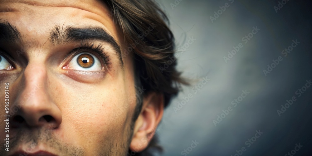 Close-up of a person looking at something in awe, amazed, fascinated, wonder, curiosity, contemplation Close-up of a person looking at something in awe, amazed, fascinated, wonder, curiosity, contemplation