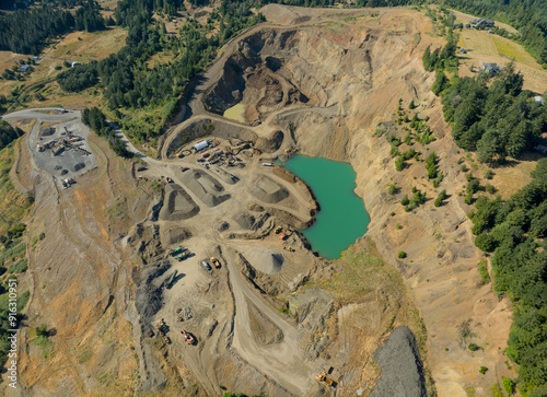 A large open pit mine with a large body of water in the middle