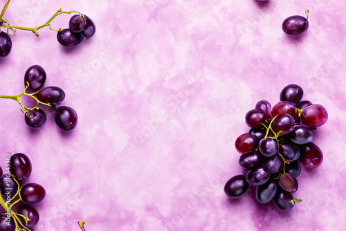 Vibrant Product Background with Fresh Purple Grapes on Soft Pink Surface for Food and Beverage Branding
