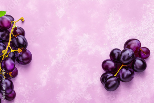 Vibrant Product Background with Fresh Purple Grapes on Soft Pink Surface for Food and Beverage Branding
