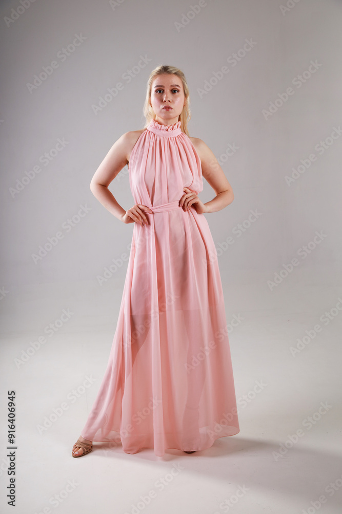 Portrait of beautiful young blonde woman in pink dress Portrait of beautiful young blonde woman in pink dress