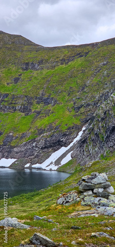 climbing Romsdalseggen trail in Andalsnes Norway in summer with rocky mountains in the background photo