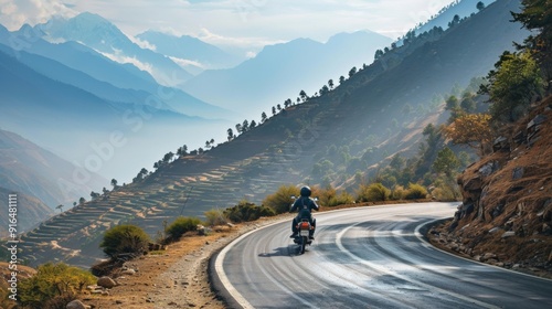 motorcycle traveling on roads with views of mountains on a sunny day photo