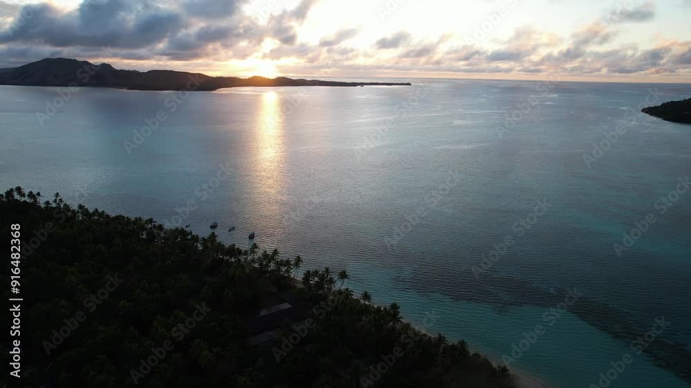 Aerial view above Tavewa Island in the Yasawa Islands Fiji at sunrise - Tropical paradise Island in the south Pacific
