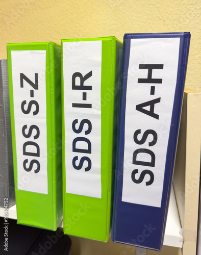 Safety Data Sheets, SDS binders on a shelf of a maintenance repair shop.