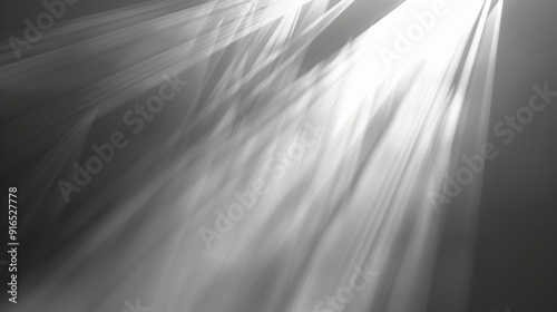 White light rays penetrate a grey, foggy atmosphere, creating a serene and peaceful ambiance, highlighting the contrast between light and dark.