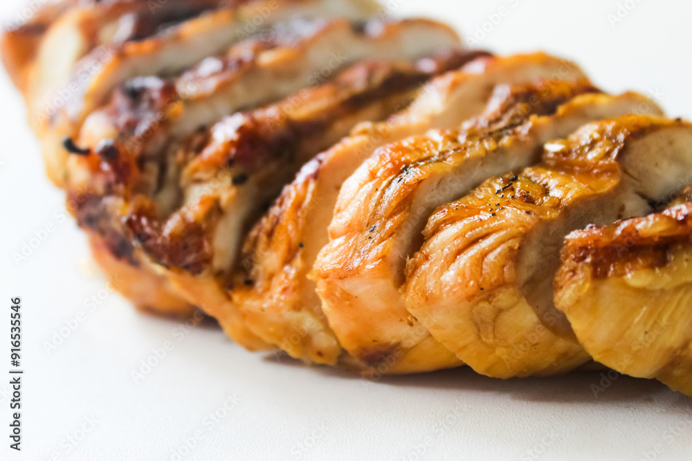 close-up of grilled chicken breast slices on white background close-up of grilled chicken breast slices on white background