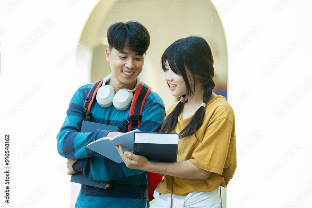 Students smiling while studying together on campus Students smiling while studying together on campus