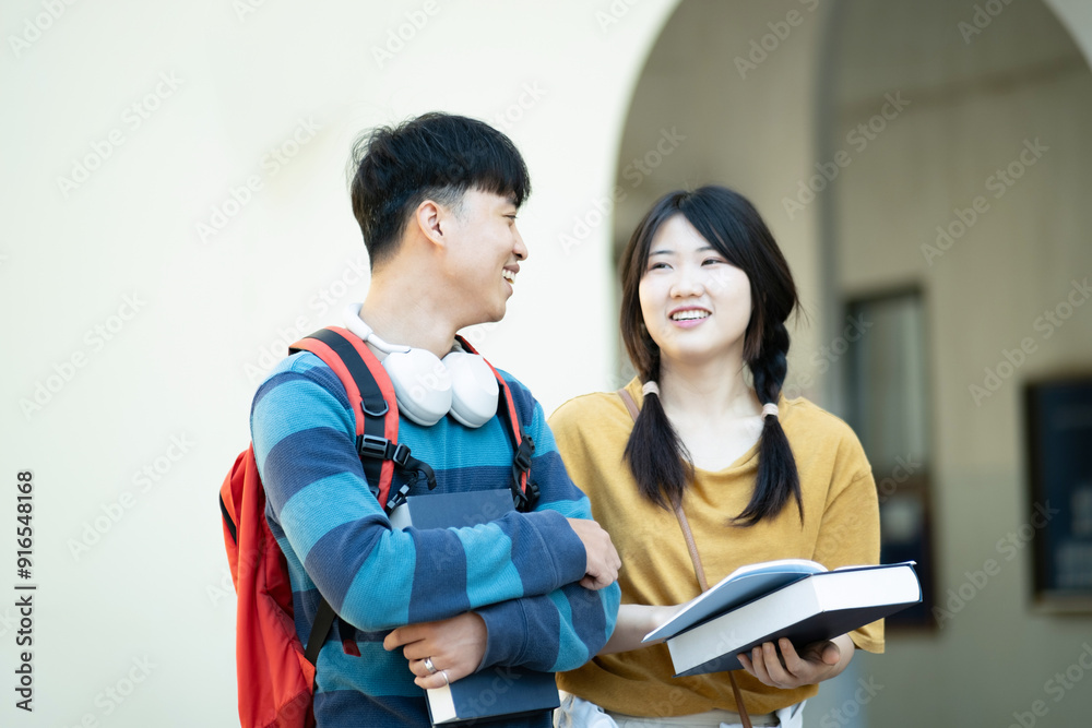 Students smiling while studying together on campus Students smiling while studying together on campus