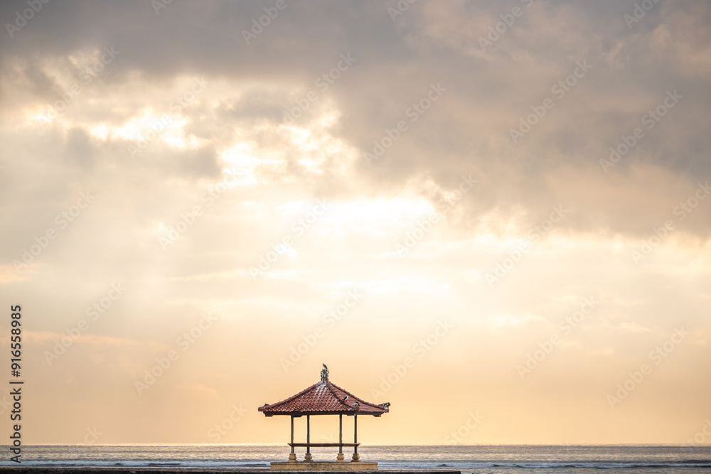 Beautiful seascape in the morning. Tropical sandy beach with breakwater and reflection of the sky in the calm water. Sanur, Bali, Indonesia Beautiful seascape in the morning. Tropical sandy beach with breakwater and reflection of the sky in the calm water. Sanur, Bali, Indonesia