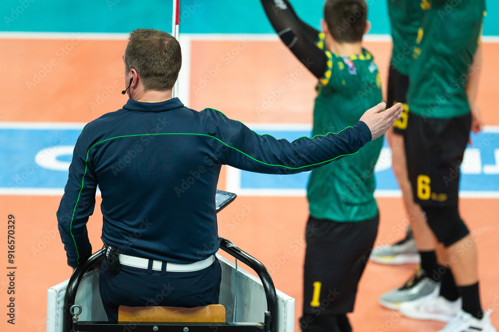The referee gives a sign with his hand during a volleyball match.