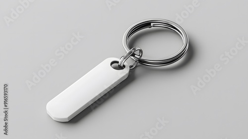 White keychain mockup displayed on a neutral grey background, with soft lighting