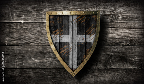 Medieval wooden triangular shield with golden brim and red black and white templar pattern design on ancient wooden background