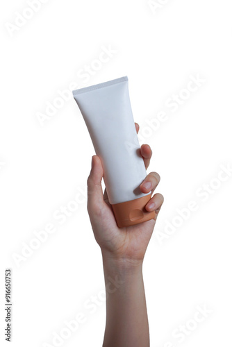 Female hand holding white tube of face and body cream mockup on without background. Concept of beauty products and branding, diecut no background