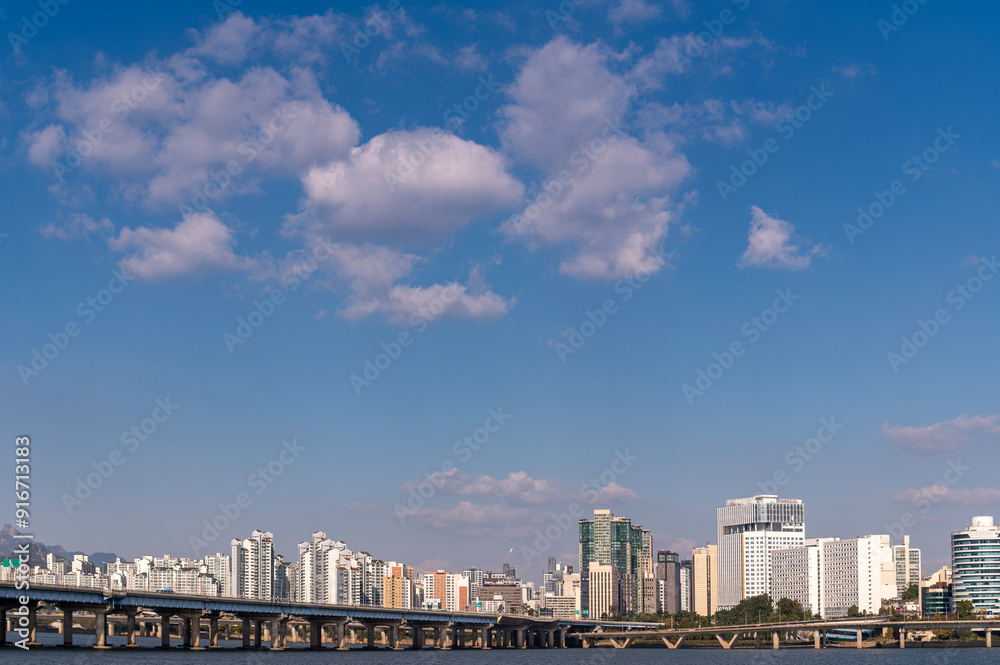 Seoul cityscapes, skyline, high rise office buildings and skyscrapers with blue sky and cloud in Seoul city, winter daylight, top view in winter, Seoul, Republic of Korea,