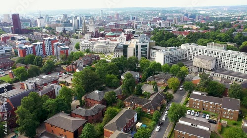 Aerial footage of the Leeds town of Headingley, the footage shows the famous Leeds University campus and the town centre in the background with roads and traffic, taken on a beautiful sunny day. photo