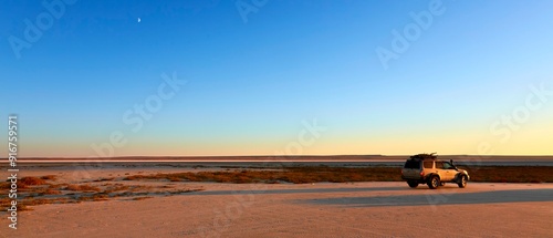 (Super wide view) SUV and tent night in the glow of the Golden Hour in Mangistau, Kazakhstan
