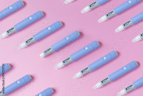 medical drug Ozempic injection lies on a pink background, top view. Medicine and weight loss, concept. injectors dosing pens for subcutaneous injection of antidiabetic medication or anti-obesity photo